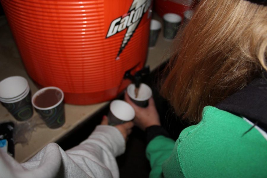 Student Council members pour hot chocolate into cups for York students.