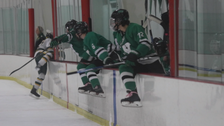 Juniors Sean McCarthy and Quinn Haller and senior Will Ciannella hop the bench for a line change.