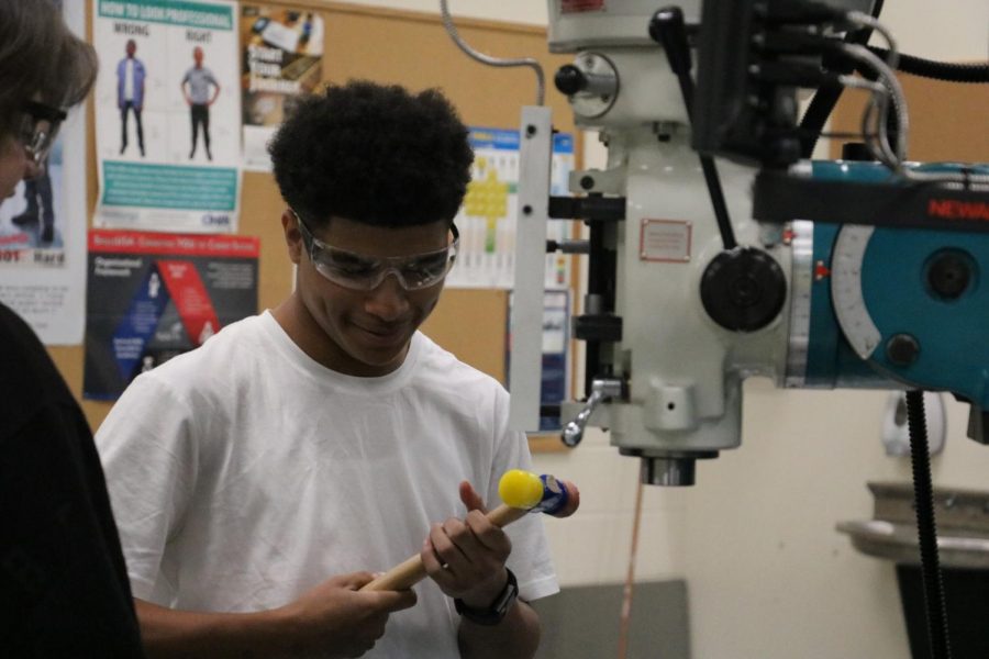 Senior Derrick Hardimon works with mallet in designing his project for the new Manufacturing class. 