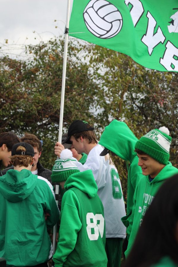 Senior Will Ahern carries the York flag into the race area. Saturday, November 2, 2019.