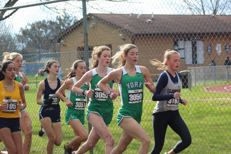 Sophomore Katelyn Winton leads the pack for the girls team with senior Lydia Hickey, freshman Bria Bennis, and sophomore Bella Swanson close behind. 