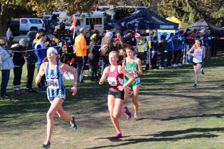 Freshman Brooke Berger sprints past the crowd at Detweiller Park. November 9, 2019.