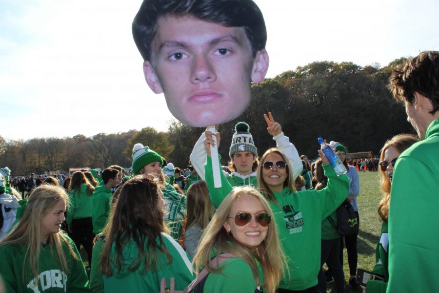 Fans pose with fat-head and get pumped up to watch the boys race. 