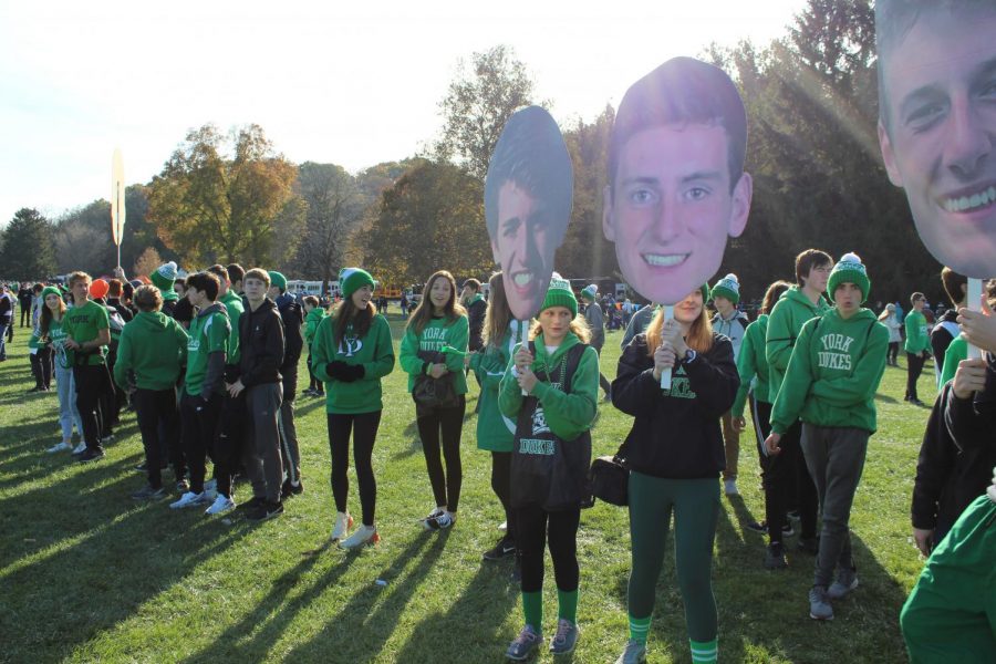 Fans assemble in a long green line to cheer on the boys as they run the first stretch of their race at Detweiller Park. 
