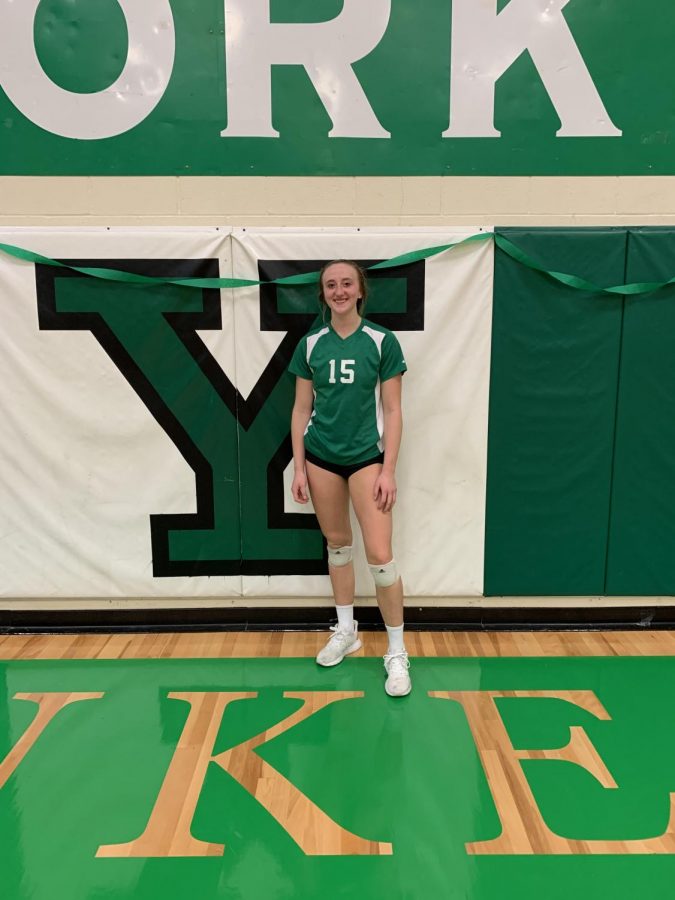 Junior, Gigi Barr, poses in front of Y logo after beating Lyons Township. 