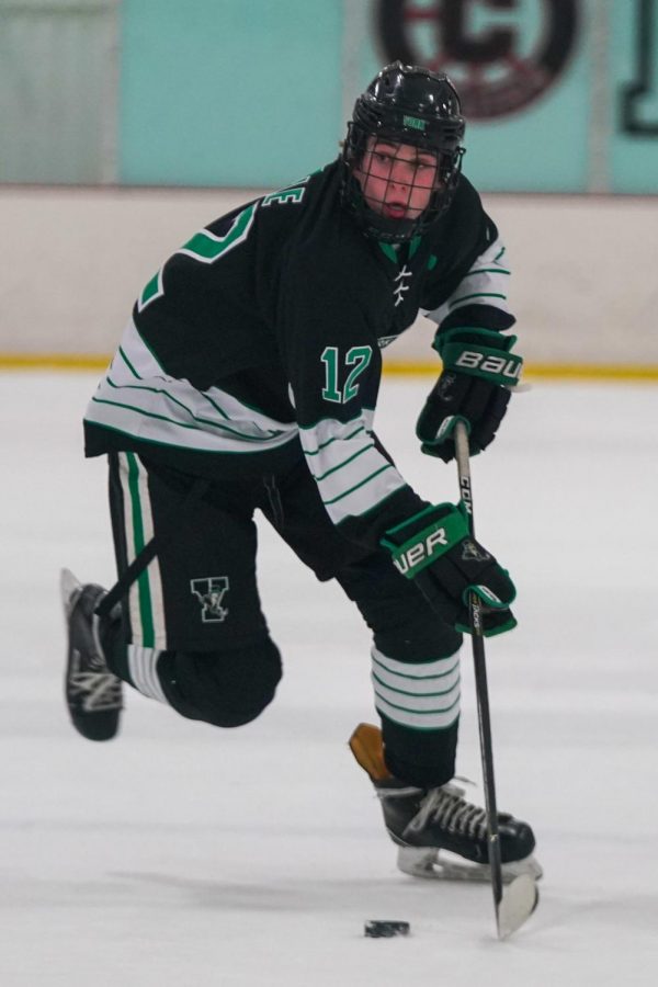 Senior and captain Jack Timble rushes the puck up through the neutral zone against Carmel Catholic.
