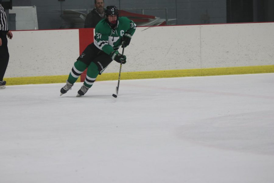 Sophomore captain Brendan Quinn rushes the puck up the neutral zone. 