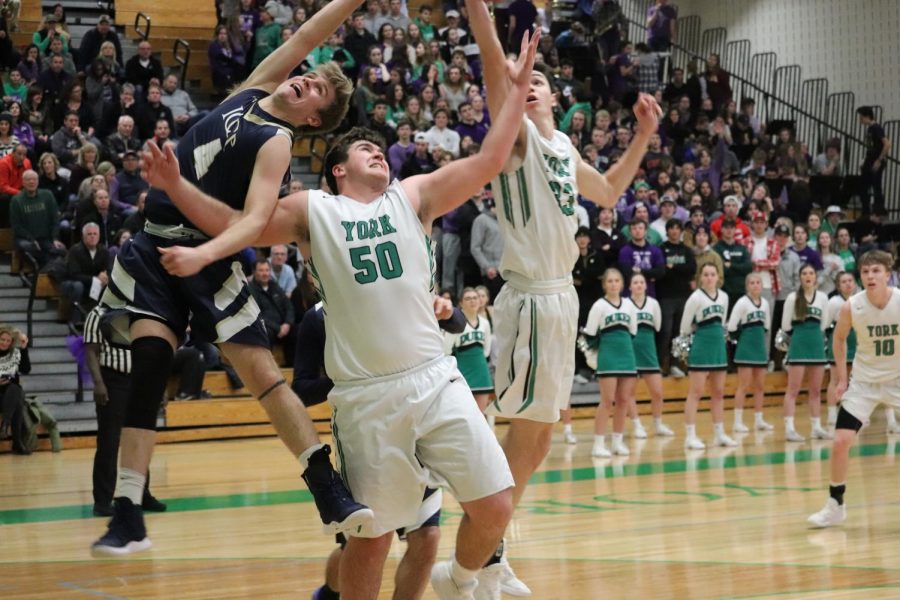 Senior Tim Glavan and sophomore, Nick Hesch get entangled for a rebound with an ICCP player.
