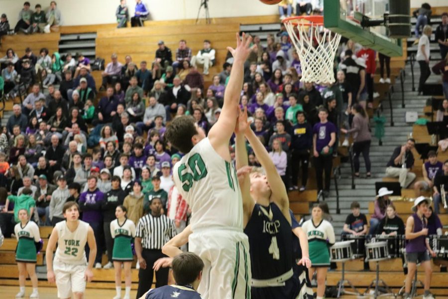 Senior Tim Glavan bodies an ICCP defender to go up and lay it off the glass for two. 