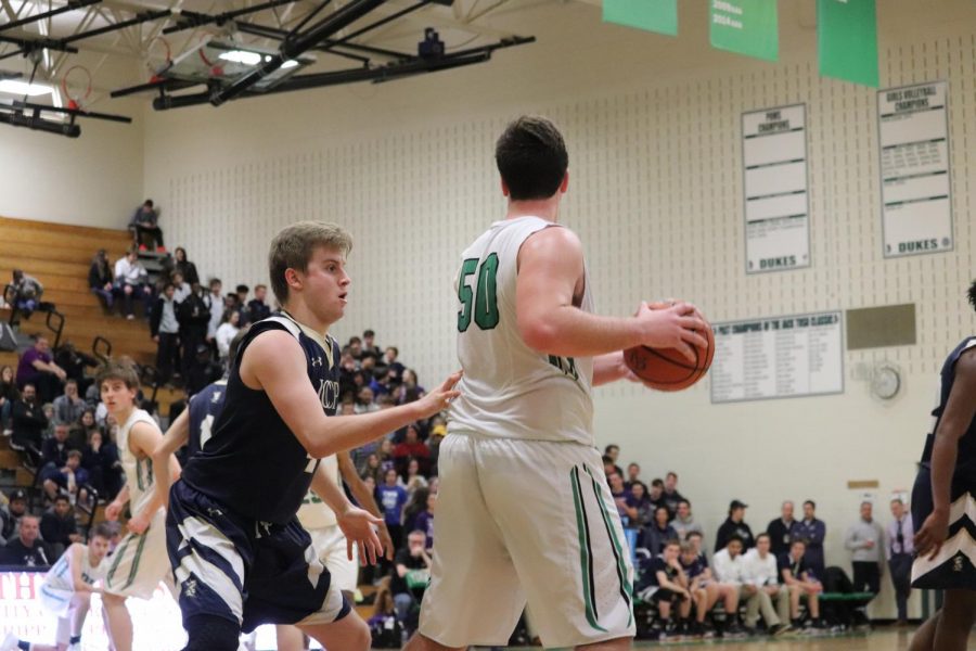 Senior Tim Glavan posts up on an ICCP defender and peers around the court for an outlet pass. 