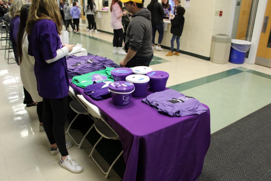 Relay for Life teams sold their merchandise during the Paint the Gym Purple game between ICCP and York on Jan. 8.