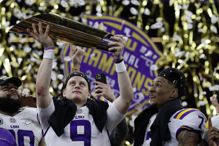 LSU quaterback Joe Burrow raises the National Championship trophy after the last game of his five year college career.