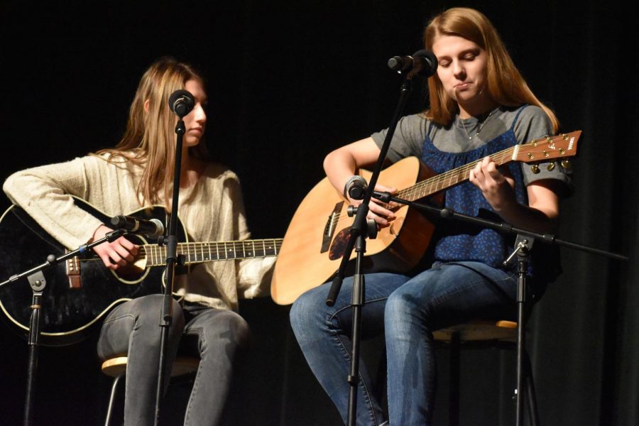 Freshmen Alyssa Poli and Quinn Olson take the stage to perform their original song Shattered during the final period of Fine Arts Week. Performing original music is a lot more personal and speical because you are putting a piece of yourself out there, which is a really nice opportunity. Poli said.