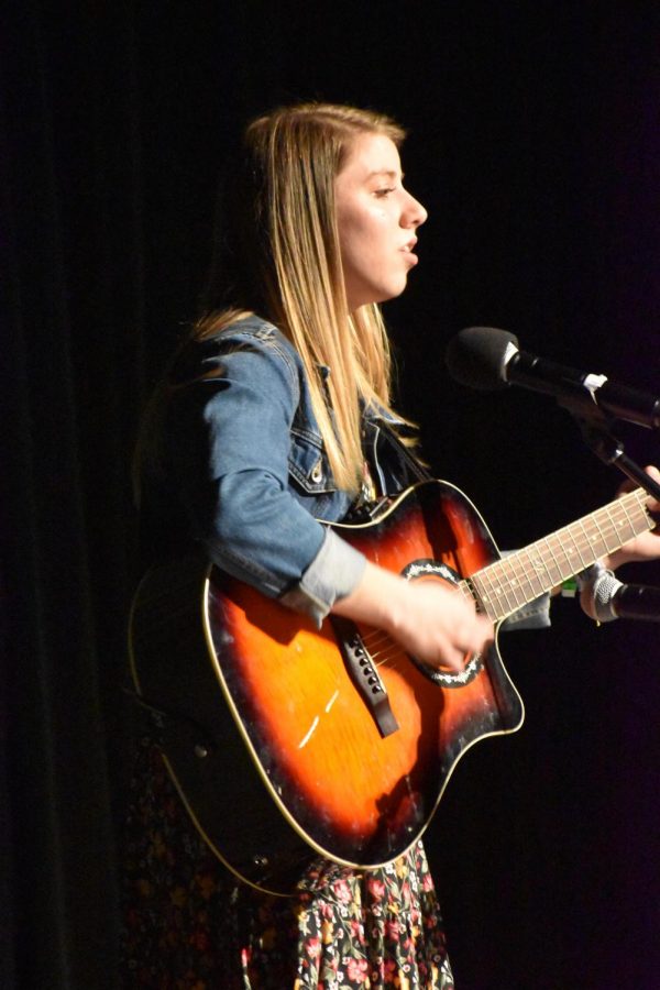Senior Rose Klinger accompanies herself on the guitar while singing her origianl song Wait For Me. There is a larger sense of community, Klinger said. you have people behind you, and we are all performing for the same reason, so it’s really special.
