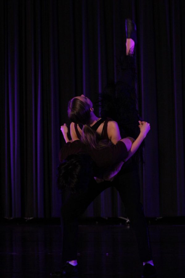 Junior Charlie Kungl lifts senior Gabrielle Brower during the partner section of Le Jazz Hot.
