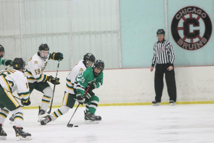 Freshman Bobby Plummer rushes to the net as three GBN opponents attempt to defend against the speedy center.
