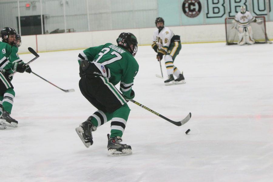 Sophomore and captain Brendan Quinn swiftly rushes the puck up the neutral zone on an odd man rush. 