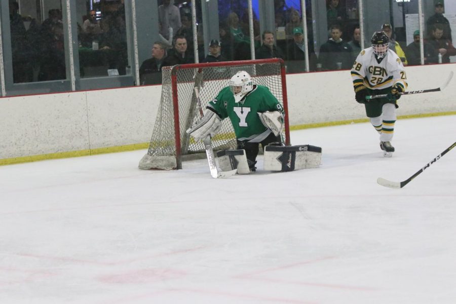 Sophomore Ben Foley recovers from a downward butterfly save, staying concentrated in a mentally demanding game. As a goalie, you have to stay focused on every next puck, Foley said. Today we did and were able to come out with a victory.
