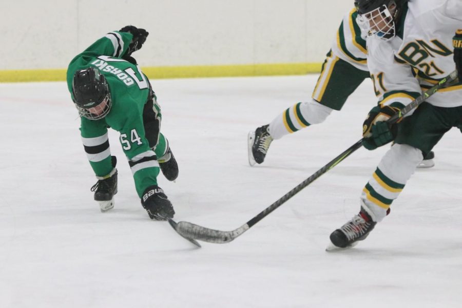 Sophomore Shane Gorski successfully knocks the puck away from GBN forward. 