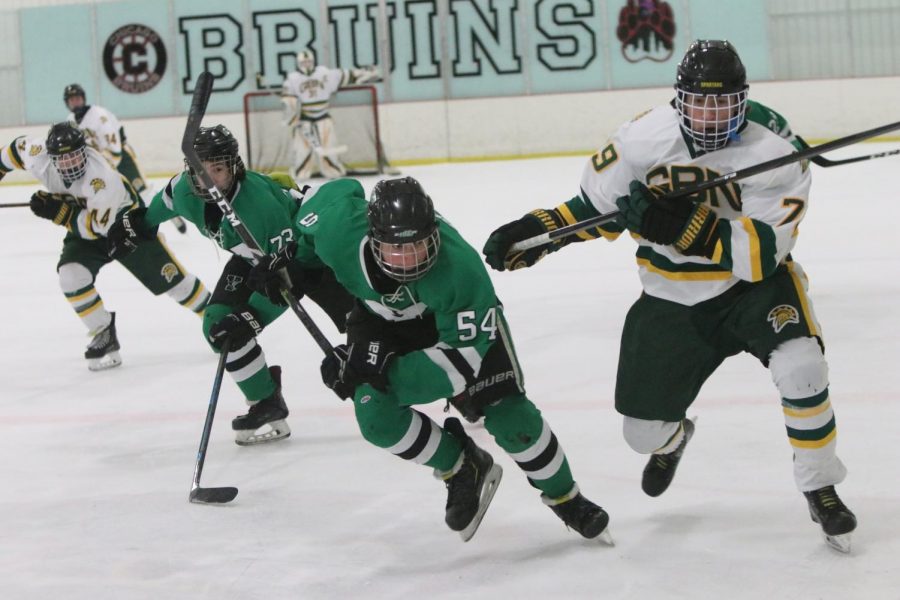 Sophomores Shane Gorski and Jonathan Wood rapidly race for the puck, exerting a relentless speed.