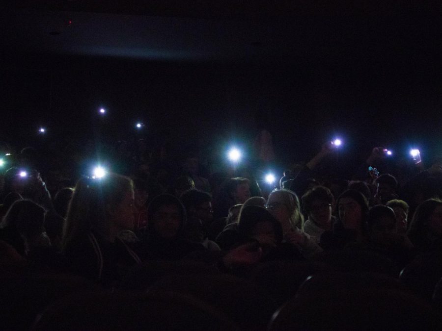 York students raise their phone flashlights during a slow-paced Comedie song. 