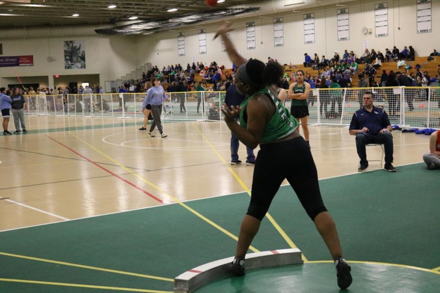 Senior Wendy Ofosu throws the shot put into the air as she competes at the varsity level at the York Invite #3.