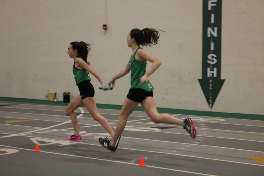 Sophomore Allison Fitzgibbons exchanges the baton to her teammate, freshman Bria Bennis, in the frosh/soph 4X800m relay at the York Invite #3. 