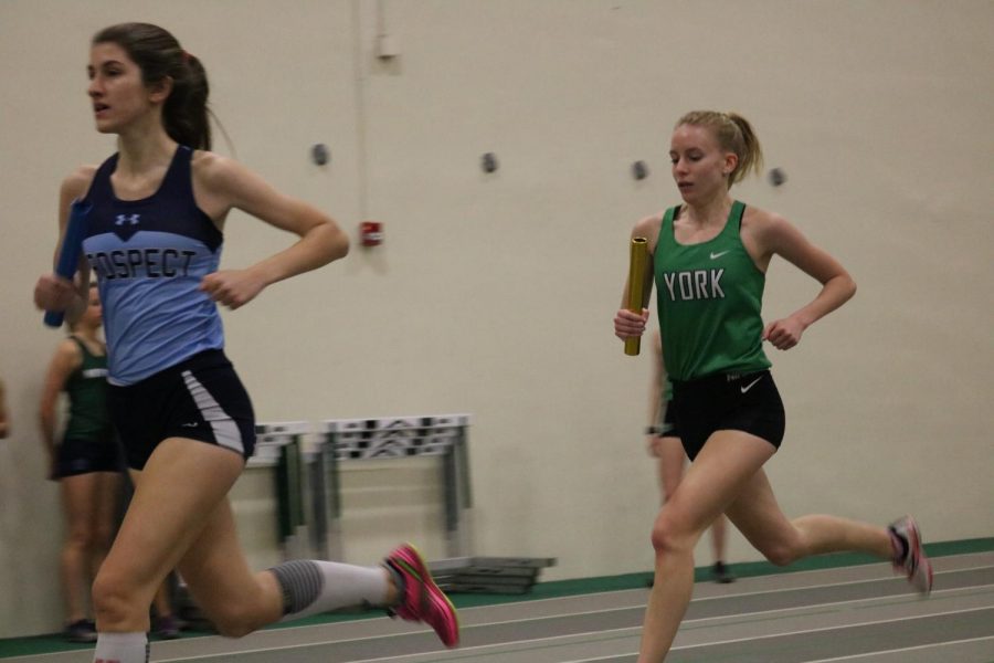 Senior Emma Kern, first runner in the varsity 4X800m relay, fights to find her team a good spot in the front of the pack.