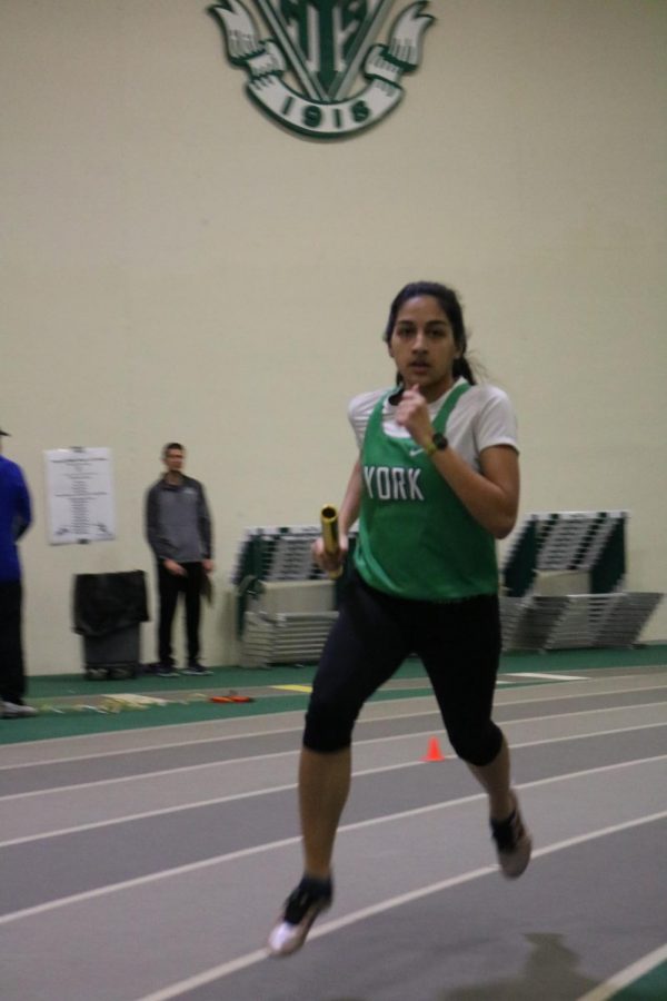 Senior Ayesha Siddiqi flies through the air as she catches up with the competition in the varsity 4X800m relay.