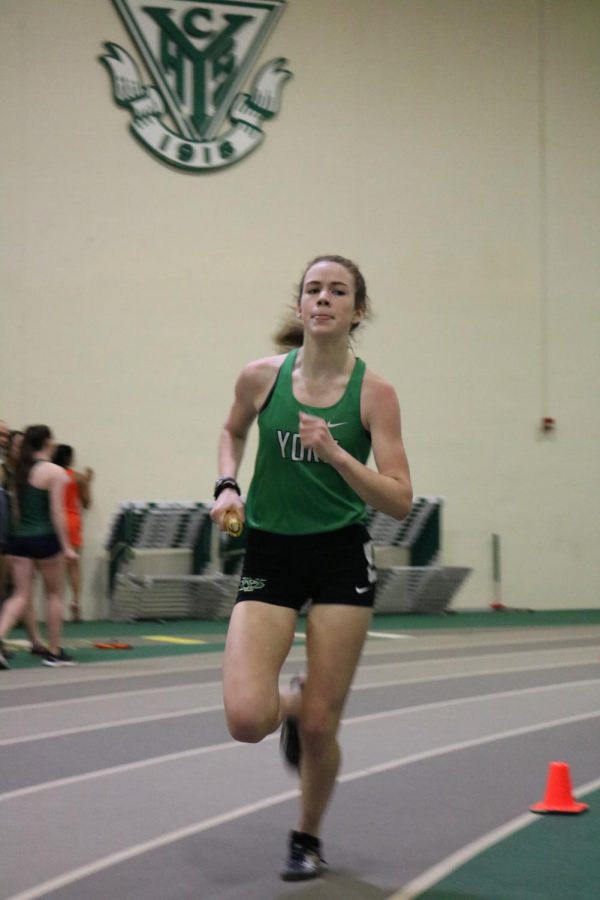 Senior Lydia Hickey sprints past in the 4X800m relay at the York Invite #3.