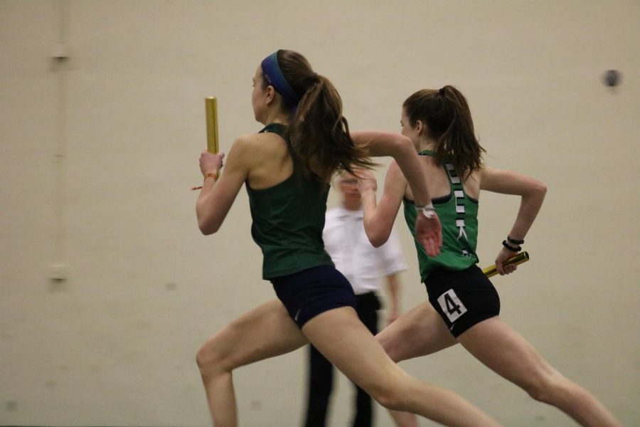 Senior Lydia Hickey competes fiercely for first place in the varsity 4X800m relay.