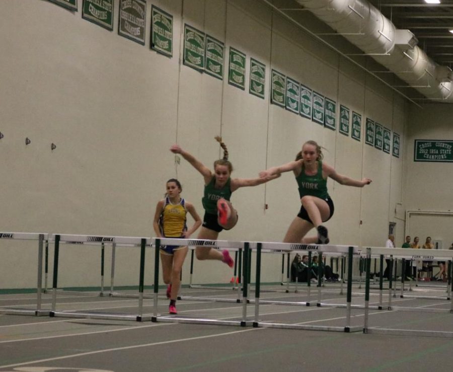 Freshman Natalie Werner and sophomore Siobhan OConnor compete in the frosh/soph 55m hurdles.