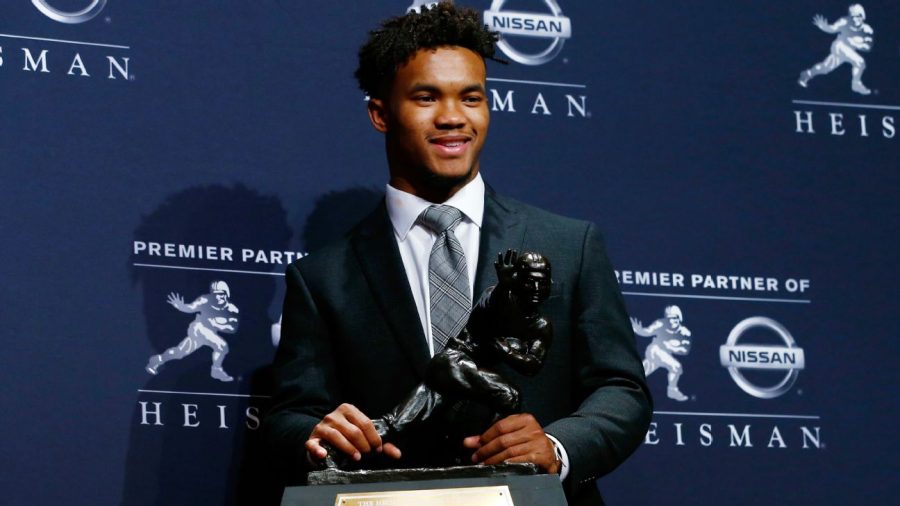 Kyler Murray holds the Heisman Trophy after winning the award in 2019, becoming the third Oklahoma quarterback to do so since 2010 (Bradford, Mayfield).