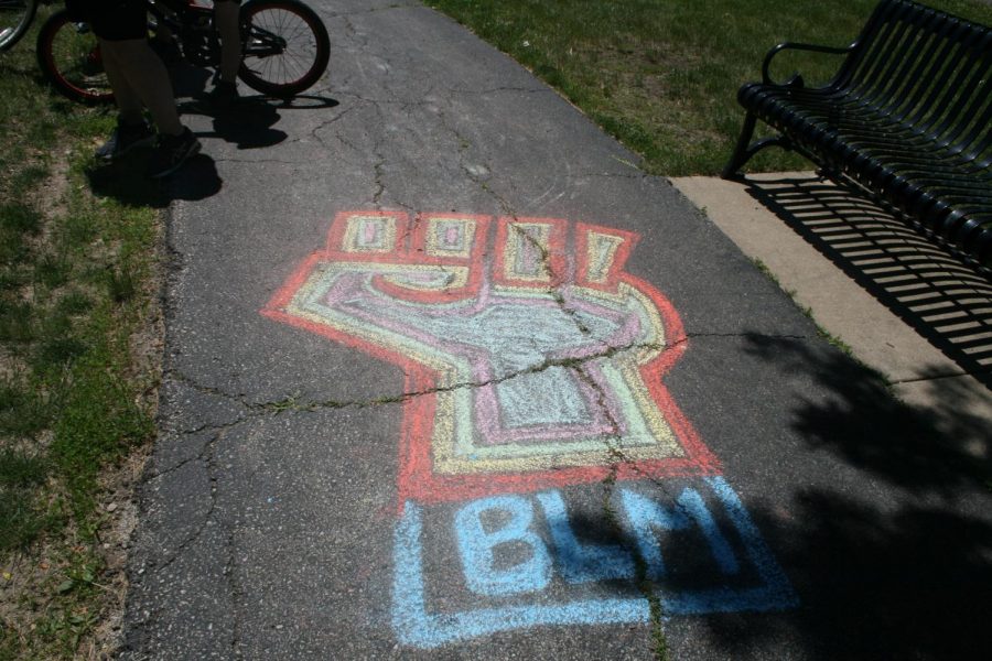 At the Elmhurst March for Equality, the sidewalks surrounding Wilder Park feature chalk designs drawn prior to the arrival of protesters. June 13, 2020.