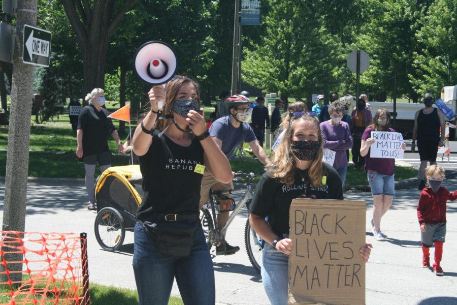 As the Elmhurst March for Equality begins, graduate Camille Steahly (19) leads the chant defund police, refund communities. June 13, 2020.