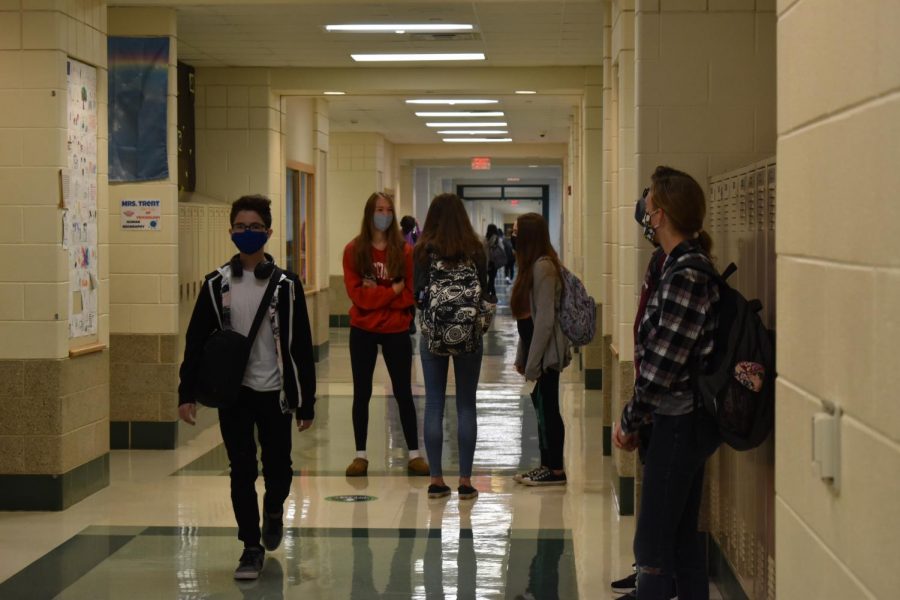 York sophomores join the freshmen for hybrid learning. On the third floor, students talked outside their classrooms prior to the first bell. All students were required to wear masks throughout the school day. Sept. 28, 2020.