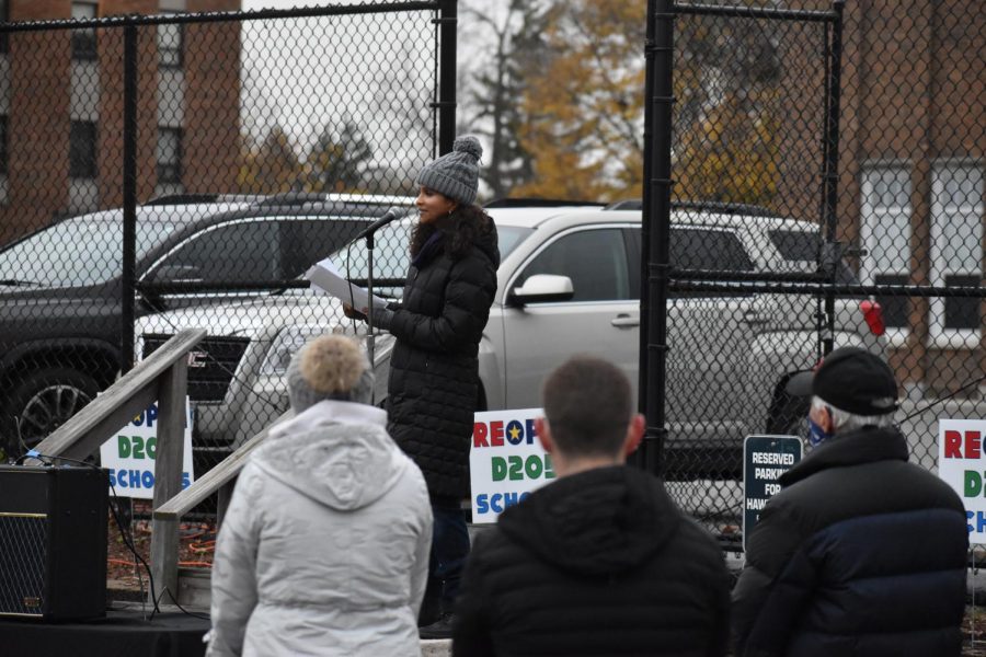 Parents and students from D205 gather in the district office parking lot to protest the full return to remote learning. Parent Shirley Stilson spoke to the crowd about their belief in a lack of on campus transmission across school districts in the nation. “Teachers with risk factors should be able to stay at home, and by the same token, parents who choose to keep their kids in remote learning should have that option as well,” Stilson said. Oct. 27, 2020.