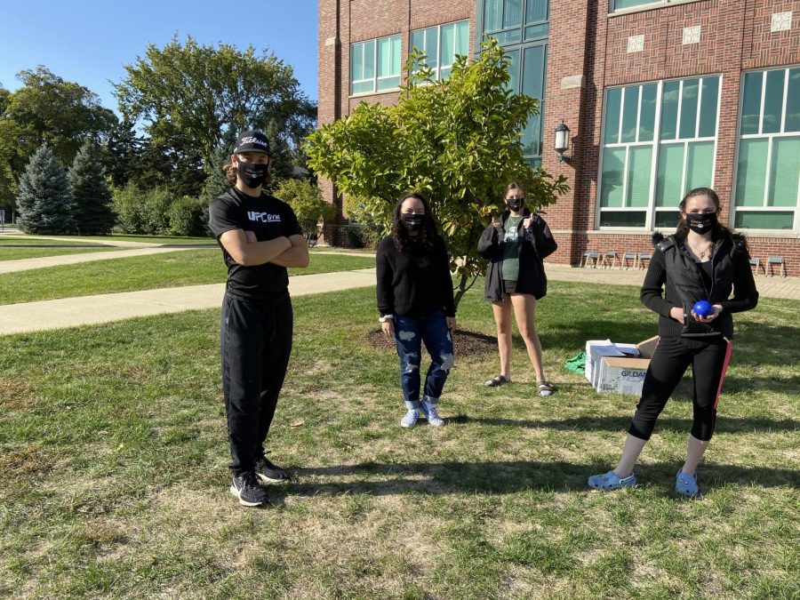 Senior Ricky Pesek and juniors Reese Krauter, Co-President Maria Chornij and Cayliann Gillie sport Italian Club masks while continuing a tight game of bocce ball. 