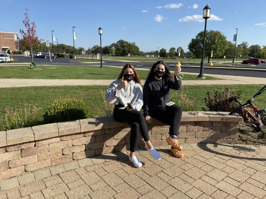 Senior Gianna Konieczny and junior and Co-President Lily Rende enjoy the temperate day for an outdoor meeting while wearing their Italian Club masks. 