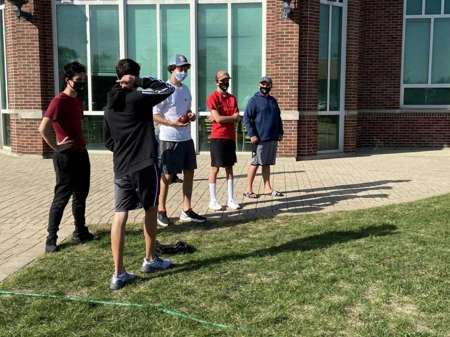 Junior Rocco Spizzirri, sophomores Noah Balice and Jack Imburgia, and freshmen Brandon Cello and Max Rallo strategically plan their next moves in an intense match of bocce ball.    