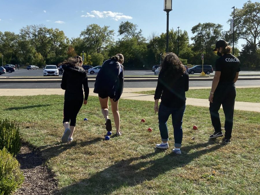 Juniors Cayliann Gillie, Co-President Maria Chornij, Reese Krauter and senior Ricky Pesek race to declare a winner in this round of bocce ball. 