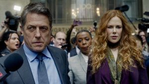 Still of Jonathan (Hugh Grant), Grace (Nicole Kidman), and Haley (Noma Dumezweni) being hounded by the press outside the courtroom on The Undoing (Photo courtesy of HBO). 