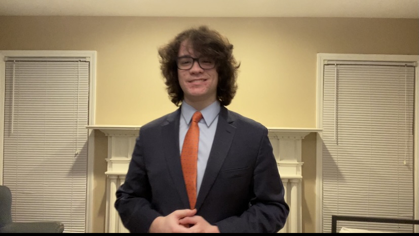 Photo of James Golen delivering his final round speech, recording himself to be viewed in a later ceremony. Golen received this ceremony after being crowned State Champion in both extemporaneous and impromptu speaking at the IHSA Speech State Series.