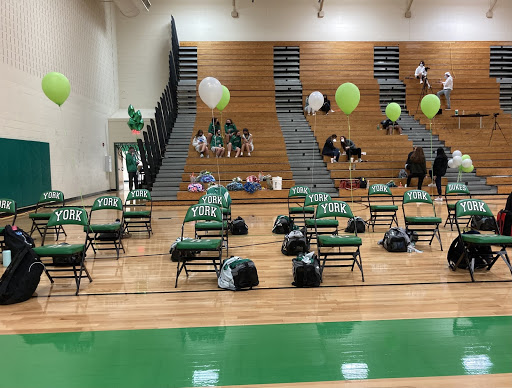 For decoration, people tied green and white balloons to the seniors chairs. “Seeing the whole gym decorated for us was also really cool because weve been waiting for four years to have this moment,” Rufus said.
