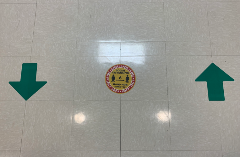 On April 12, all in-person students returned to a full eight-period schedule for the rest of the year. Arrows instruct people to keep to the right side of hallways and maintain a distance of three feet. 