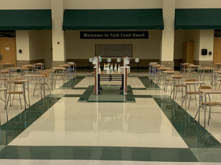 On April 12, all in-person students returned to a full eight-period schedule for the rest of the year. A table full of cleaning equipment in the lunchroom. Students are required to sanitize their desks after lunch to keep the environment clean and safe from COVID-19.