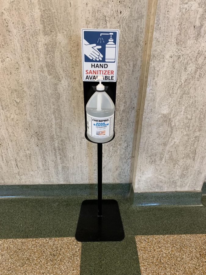 On April 12, all in-person students returned to a full eight-period schedule for the rest of the year. A stand offers hand sanitizer in the hallway in front of the auditorium. Several identical stands are located throughout hallways and classrooms.