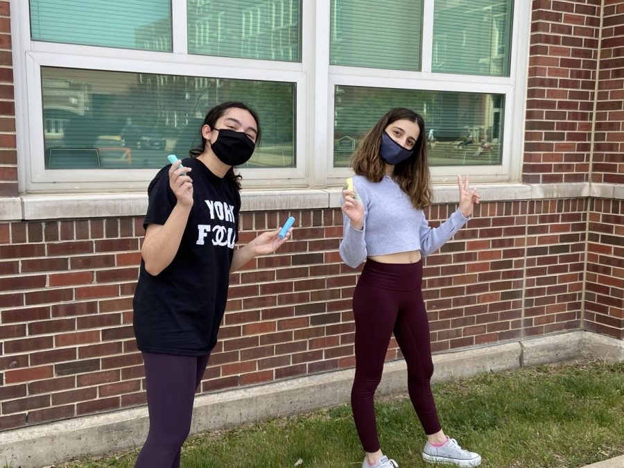 Juniors Kayla Tutunji and Olivia Hyso enjoy some sunshine and represent Art Club by leaving encouraging chalk messages to see off our seniors on Thursday May 13.