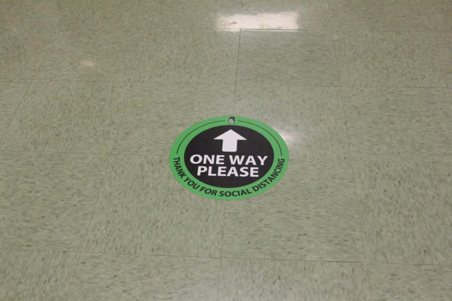 A one way sticker rests on the floor outside the atrium staircase on the 3rd floor of the academic wing. . Friday, July 2, 2021.