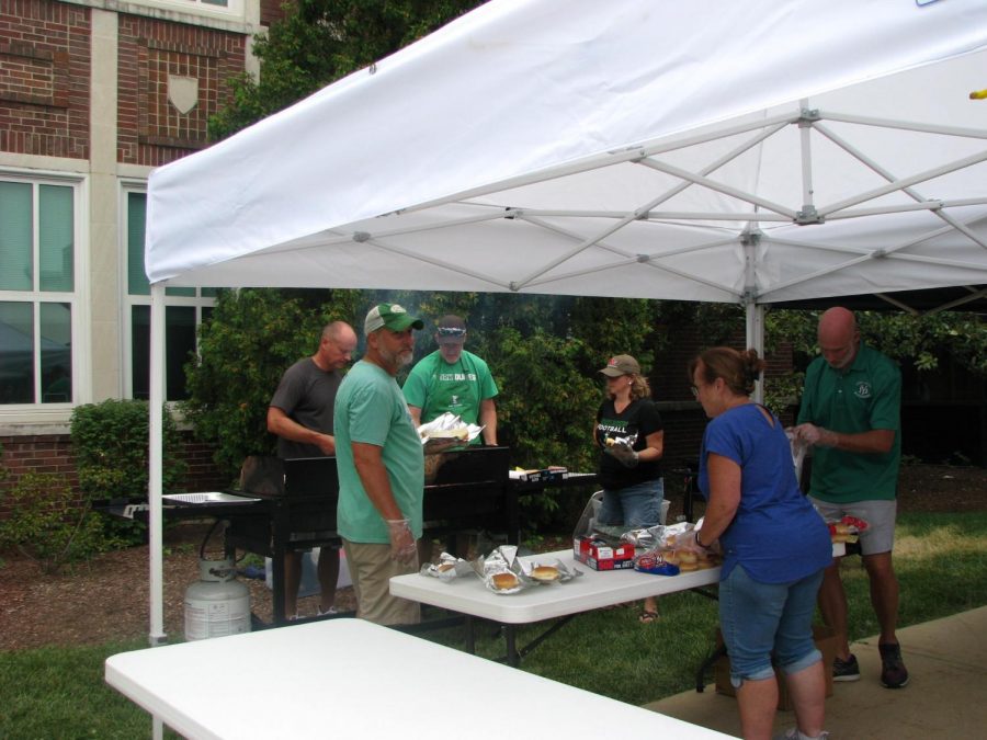 The Back to School Bash team grills and prepares hot dogs for students and families to enjoy on a day in which both hunger and anticipation ran high.